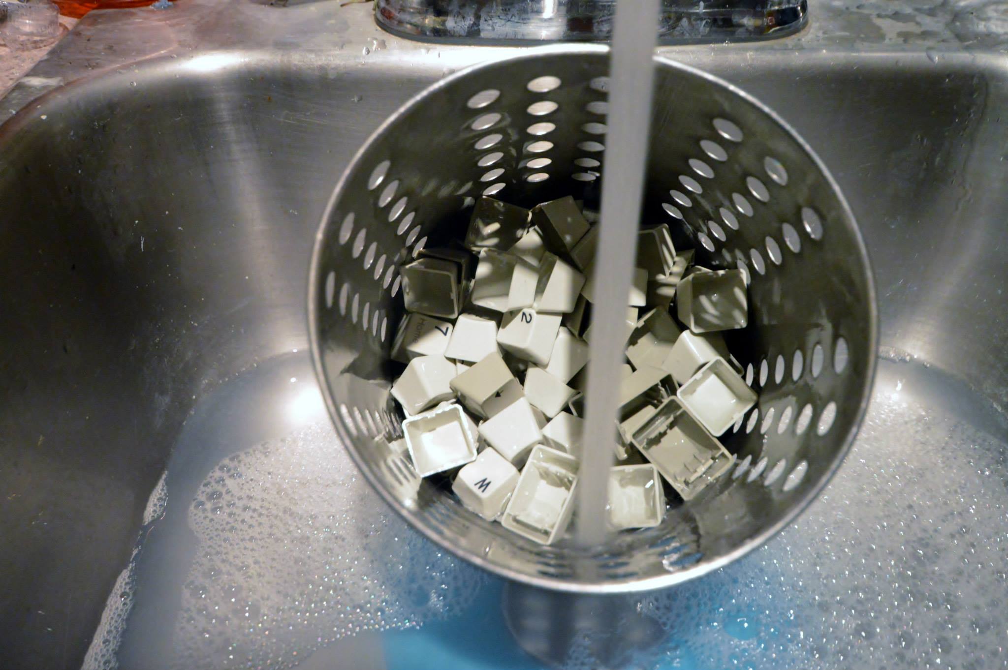 old metal cutlery basket for cleaning model M keys manually.