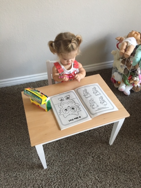 A little girl and her table and chair