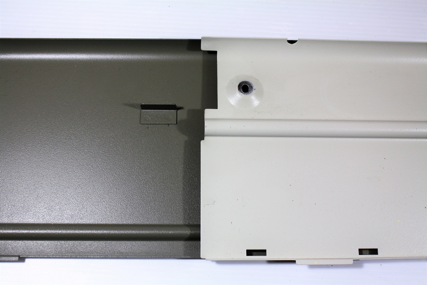 Bottom plate with the curved portion that stabilizes the keyboard mechanism from the underside.