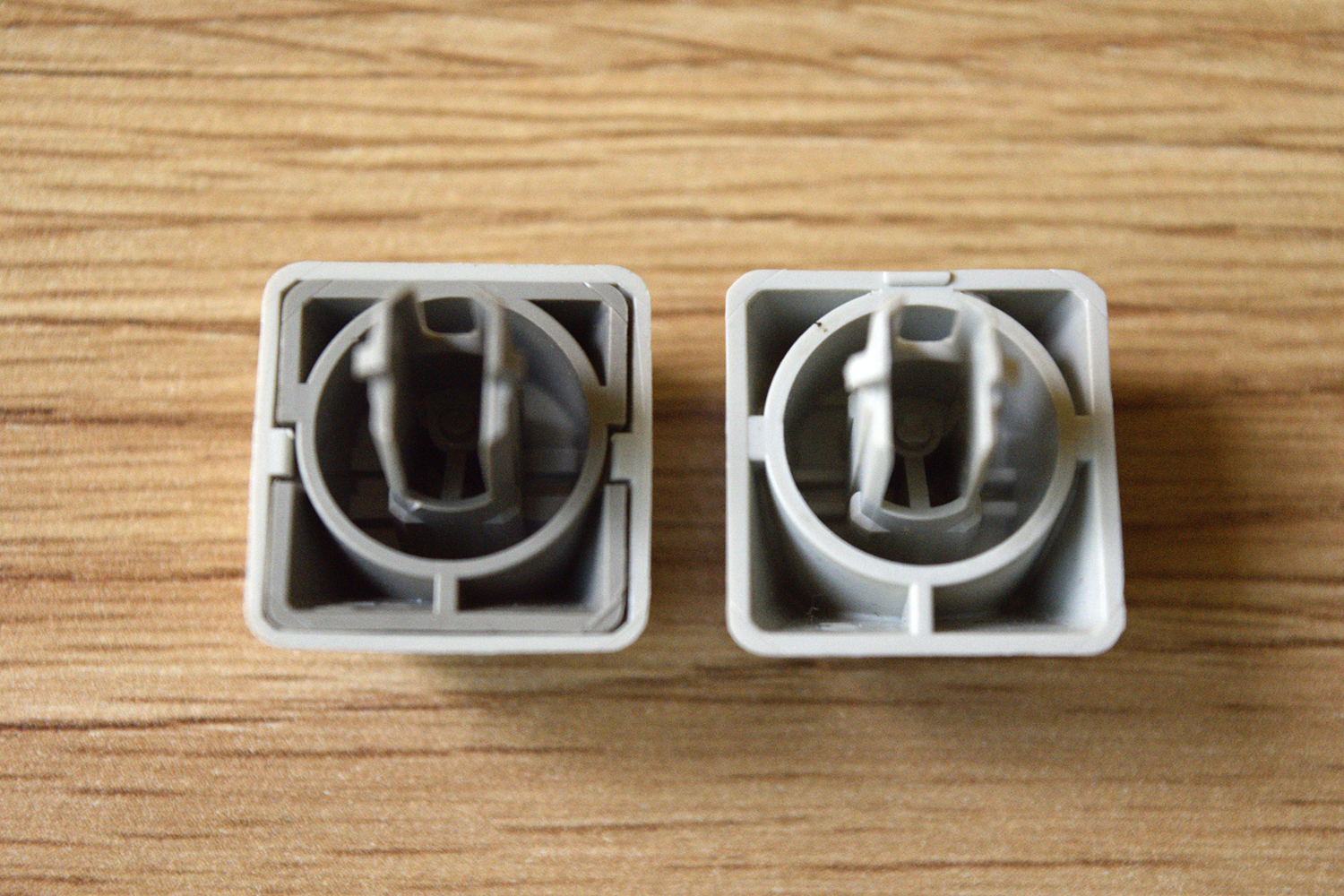IBM 95 -- Comparison of key bottoms (Left to right): IBM Model M 1390120, IBM 95.  The sprue for the 95's keycaps is underneath the cap and not on the back.