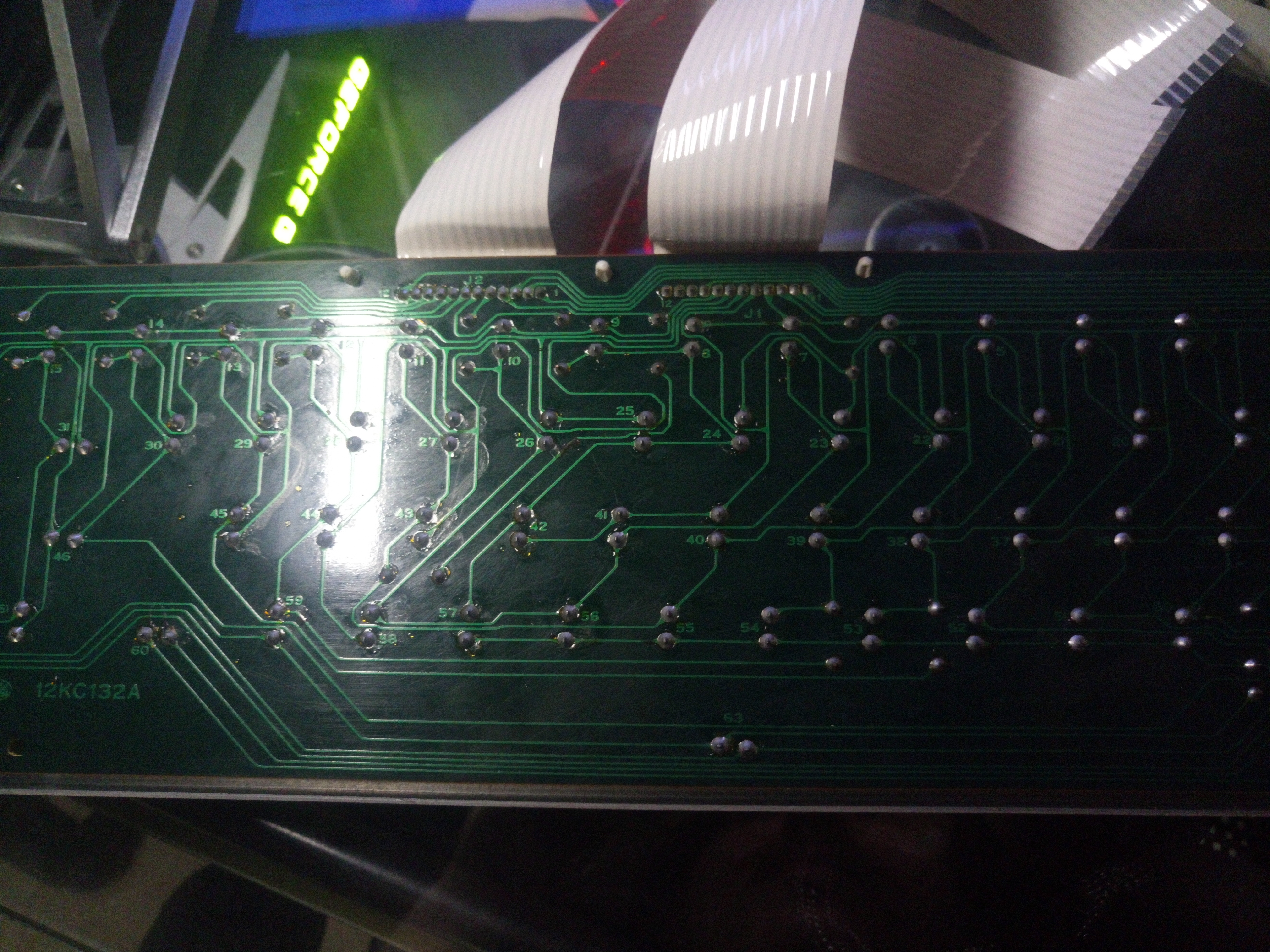 PCB in its entirety. I'm not sure if it's visible here, but the trace leading to switch 59 seems a little damaged. Or is that just flux covering it? It isn't a scratch. It's moreso like a piece of gunk sitting on the pcb, that happens to be very, very solid. Odd.