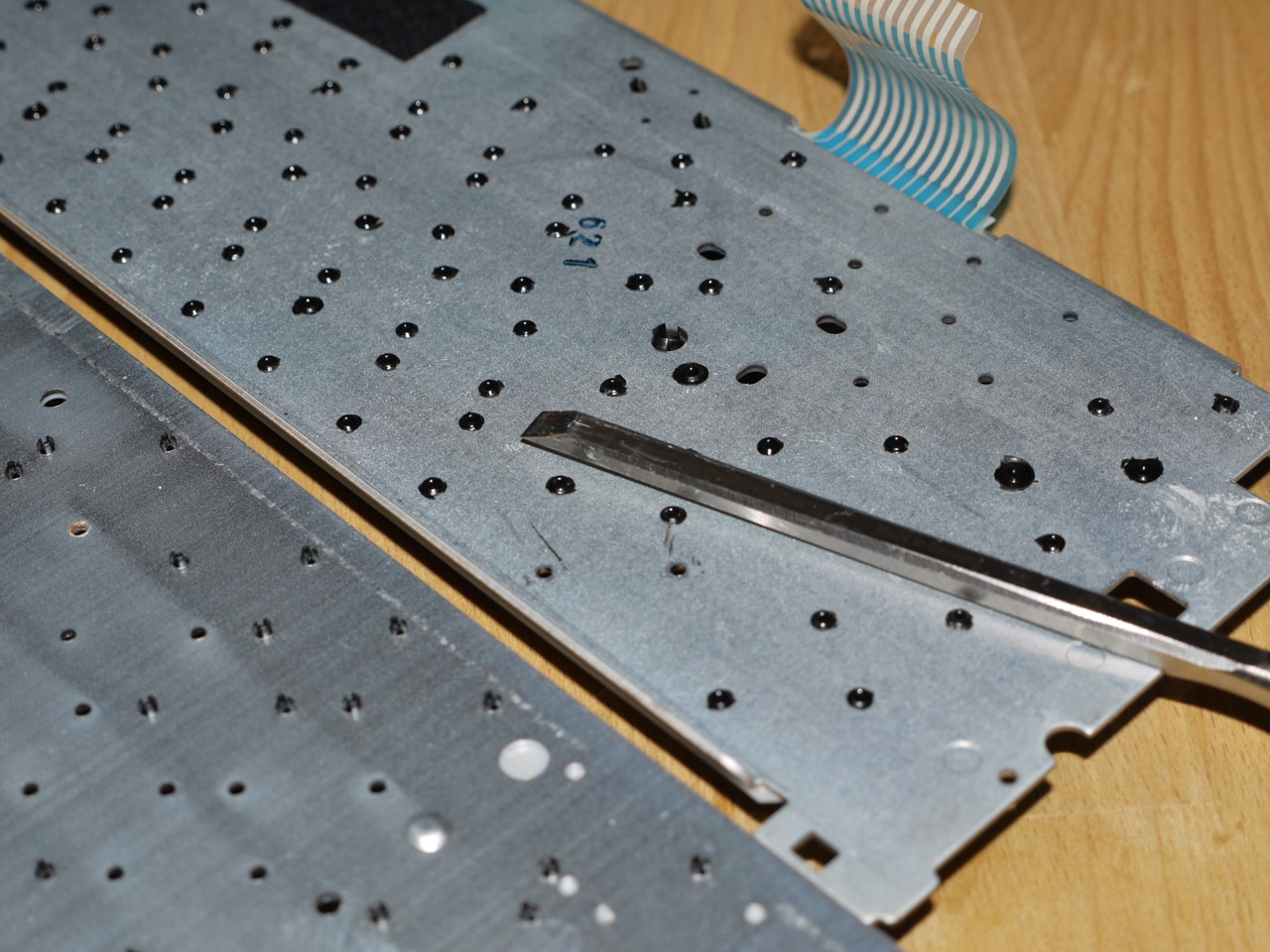 Chisel off the rivets. Switch donors in this picture: a Cherry G81 and a T+A Gabriele.