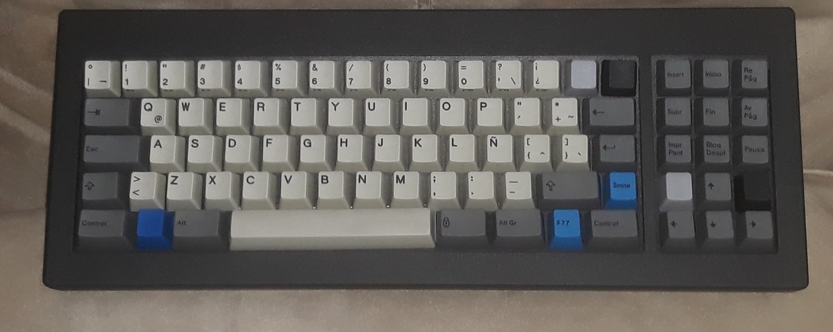 F77, esLA layout. Cream alphas, dark gray modifiers, two (Ellipse) blue mods and two black unprinted keys; UNICOMP invaders: one blue and two grays.